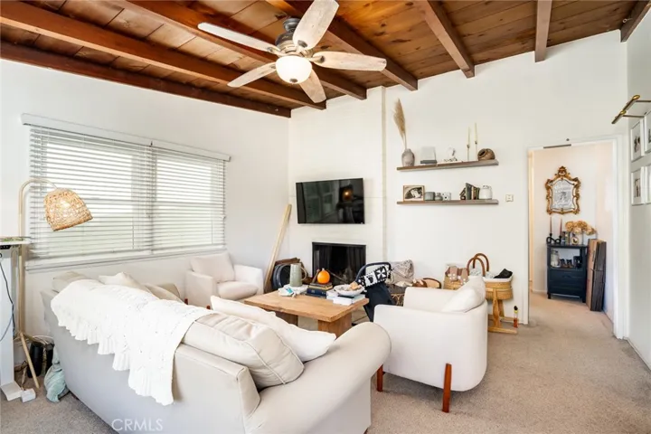 Unit 1- Livingroom with wood beam ceilings and fireplace