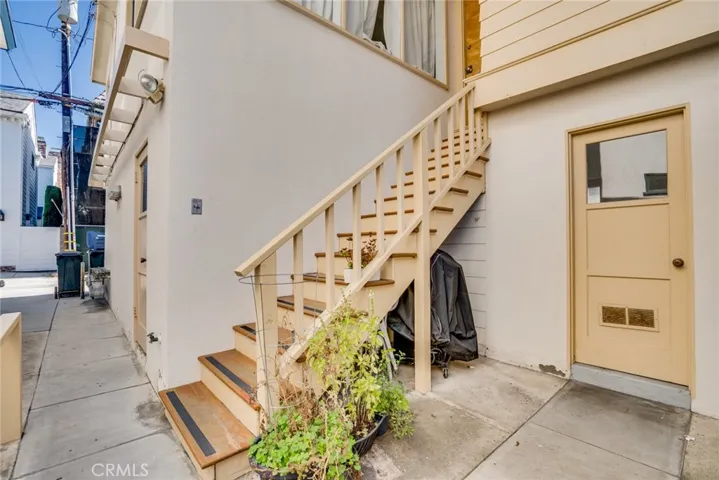 Stairs to Unit 3 and door to community laundry