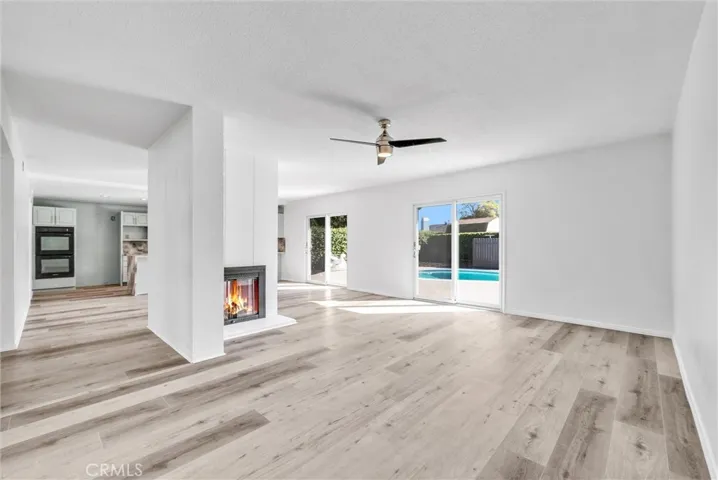 Living Room open to  Pool and Dining Double sided Fireplace
