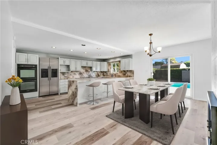 Dining with Double sided Fireplace Open to Pool