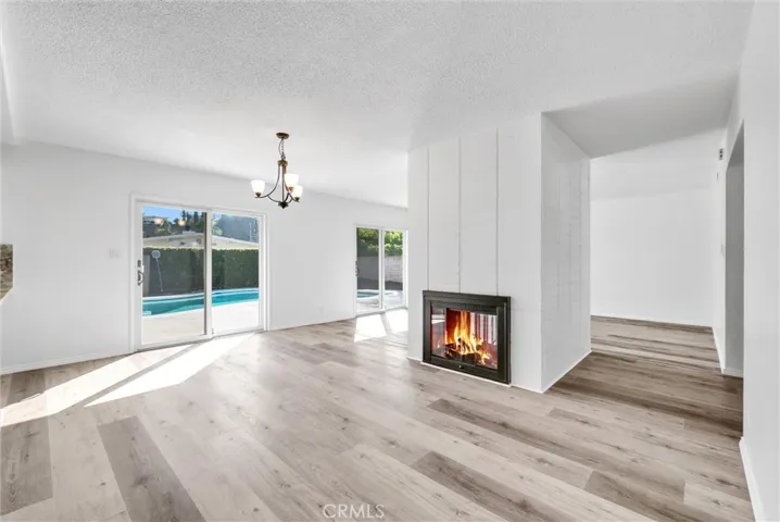 Dining with Dobule sided Fireplace open to pool and LR