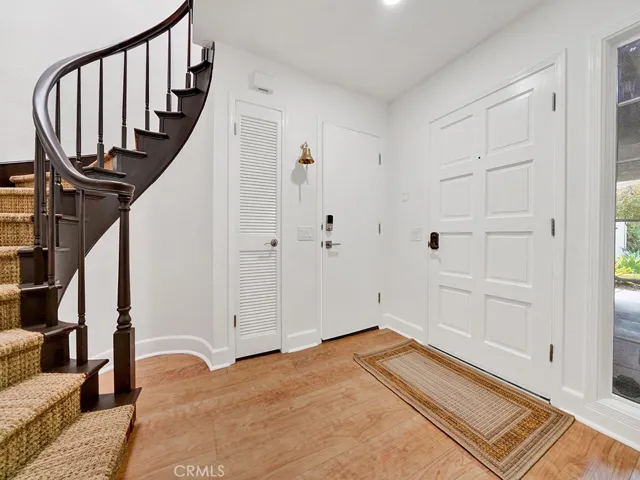 Foyer with winding staircase leading upstairs to living room, dining, kitchen, two bedroooms