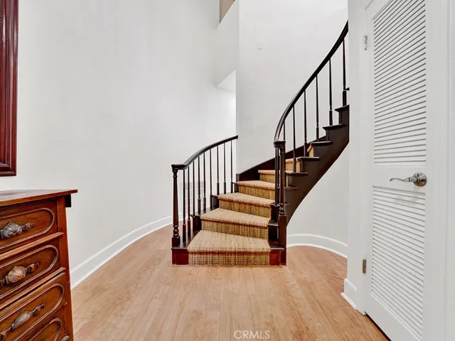 Foyer with winding staircase leading upstairs to living room, dining, kitchen, two bedroooms