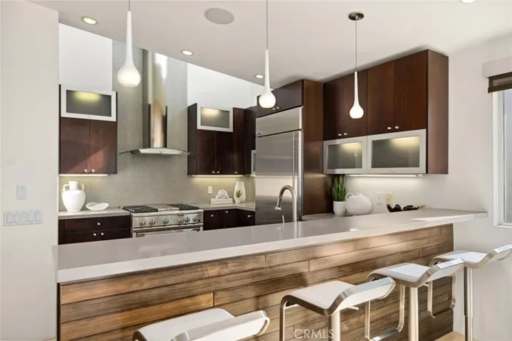 Vaulted ceilings, interior and exterior whole-house audio, motorized shades and high-end lighting fixtures add convenience and elegance throughout.