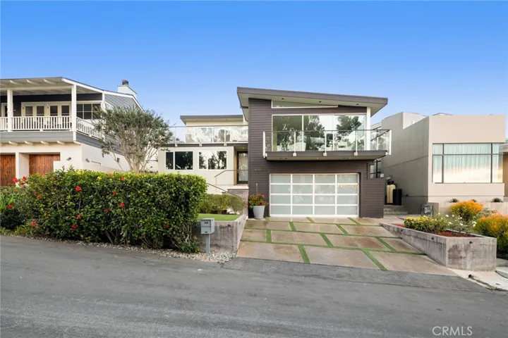 Grounds are beautifully maintained and display an inviting front yard with an attached two-car garage.