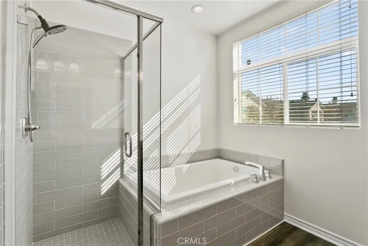 Primary bathroom shower and bathtub