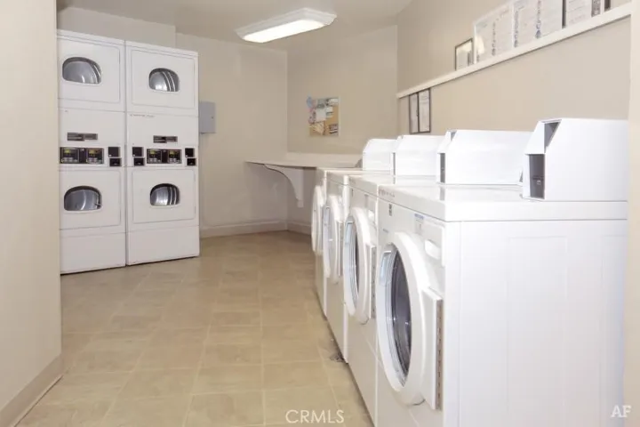 Community laundry located in garage by elevator 
