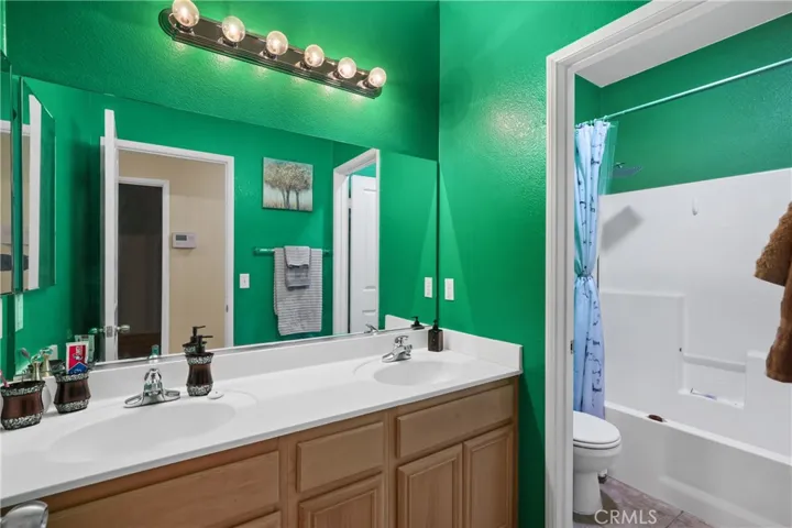 Hallway bath with showe.tub combo. door separates vanity area