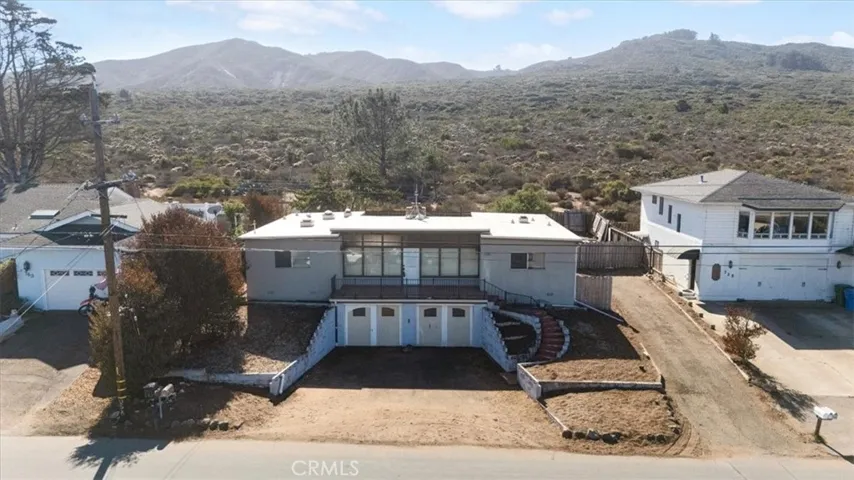 There is RV parking on the side and open space behind the home