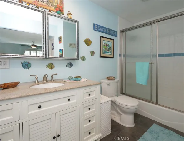 Primary Bathroom Offers a Tiled Bath/Shower and a Porcelain Tub