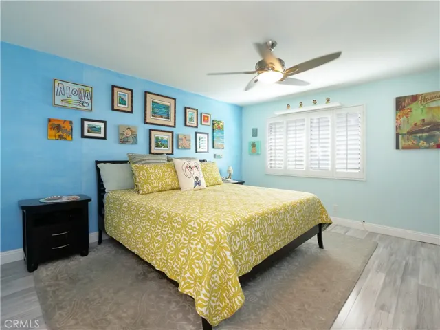 Large Primary Bedroom with Plantation Shutters, Designer Laminate Floors, and Custom Closet