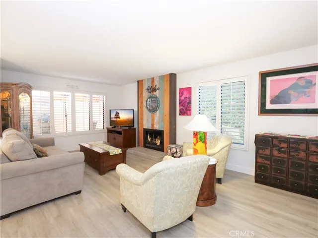 Living Room has Plantation Shutters anv View of Patio