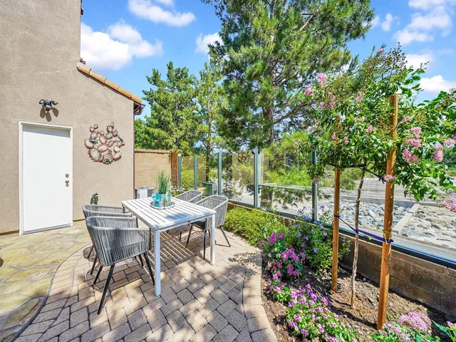 BACKYARD AND PATIO SURROUNDED BY ENCLOSED GLASS FOR VIEWING OPEN SPACE AND TRAIL