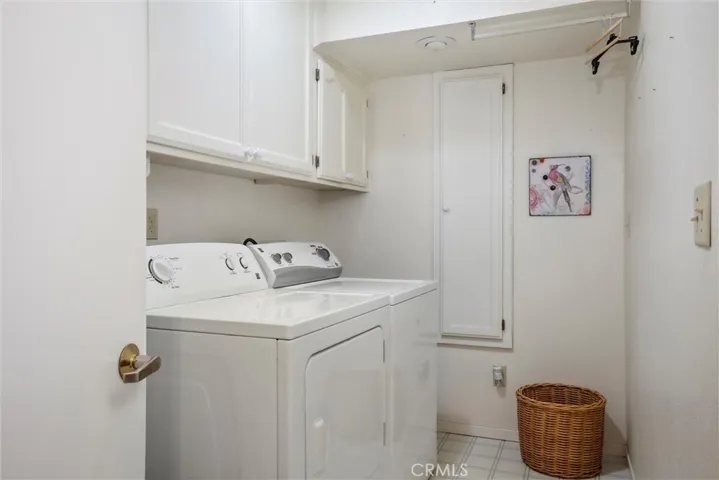 Laundry room next to attached garage.