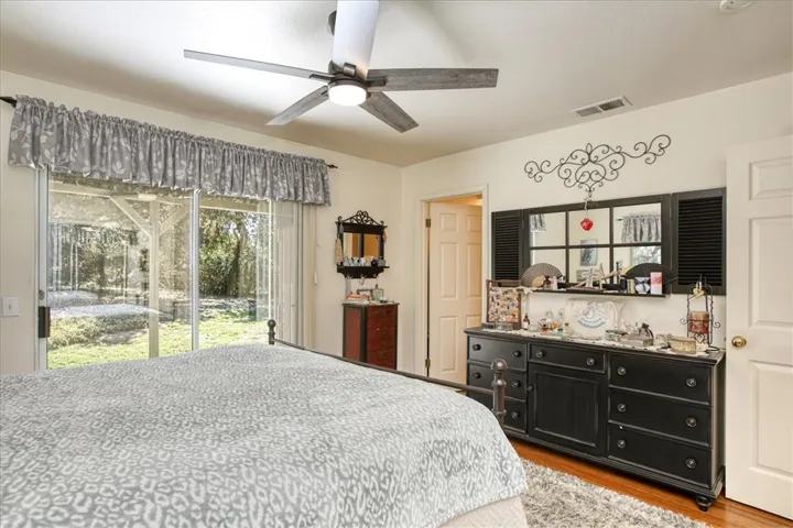 Primary bedroom with slider door to backyard.