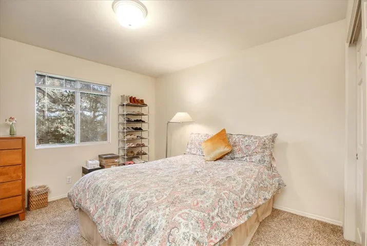 Guest bedroom with backyard views