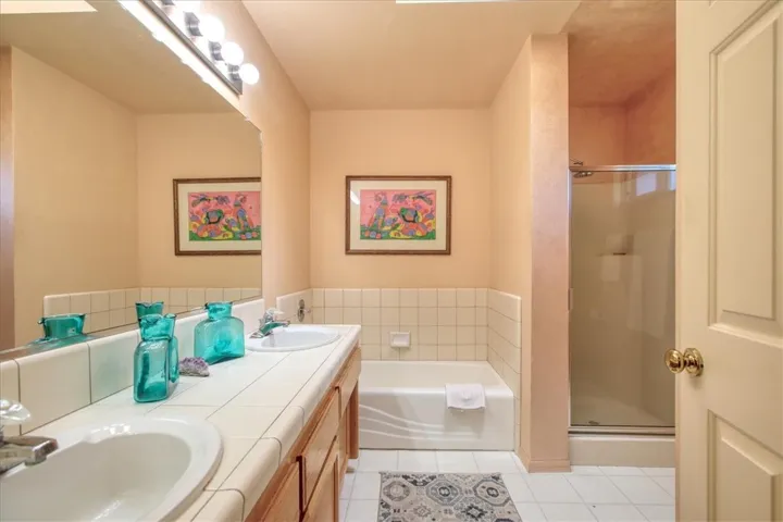 Primary full bathroom with dual vanity, tile floor