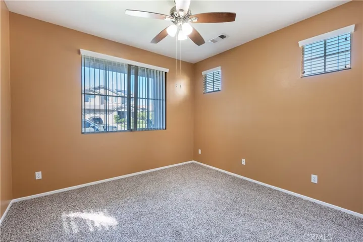 Bedroom 1 with ceiling fan and lights
