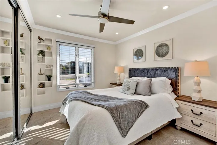 Guest bedrooms are generously sized, complete with ceiling fans, crown molding, and recessed lighting