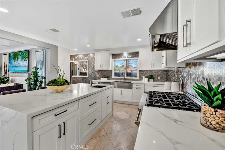 High-end stainless steel appliances include a professional-grade NXR gas range with six burners and range hood