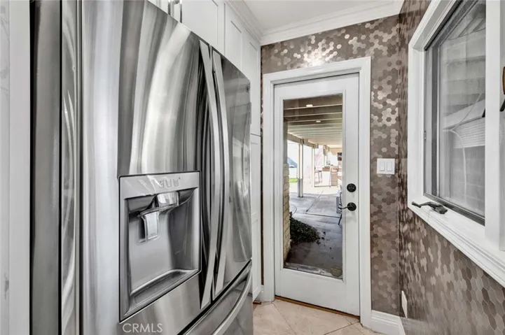 Built in refrig area with pantry and side glass door.