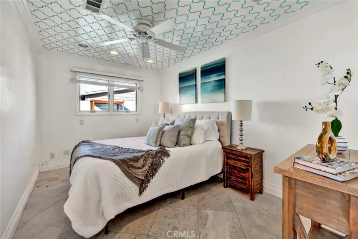 Guest bedrooms are generously sized, complete with ceiling fans, crown molding, and recessed lighting