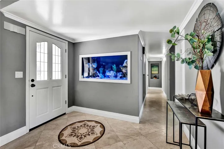 Inside, the home is fully remodeled to feature an expansive great room layout, highlighted by a large built-in fish tank wall.