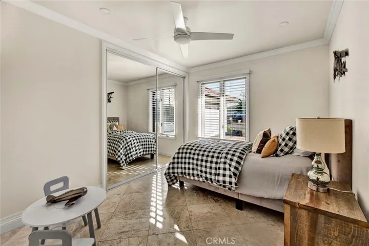 Guest bedrooms are generously sized, complete with ceiling fans, crown molding, and recessed lighting