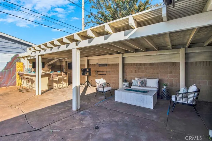 Aluma-wood patio cover, and a BBQ island with a sink, BBQ grill, and beer tap