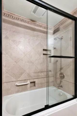 tub/shower combo with glass doors