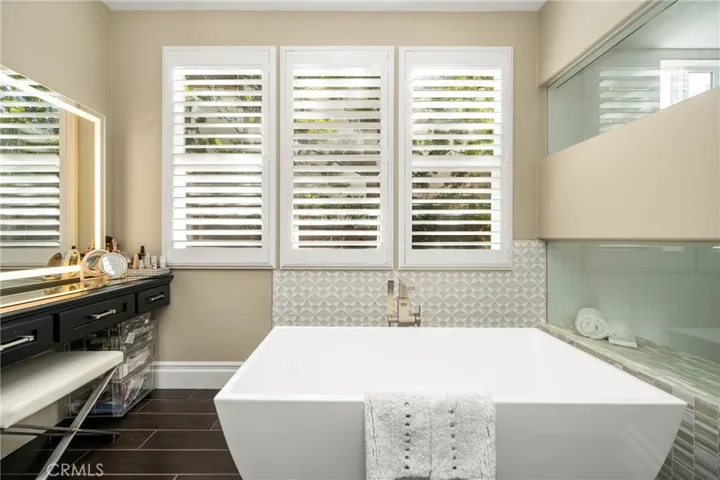 Separate Lighted Vanity and Soaking Tub in the Primary Bathroom