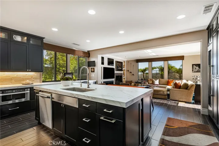 Remodeled Kitchen features New Cabinetry with Interior Organizers, Coffee Bar, Thermador Professional 6 Burner Stove, Full Size Wine Refrigerator, Thermador Built-In Refrigerator, Dekton Counters & Tile & Chrome Backsplash