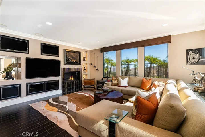 Spacious Family Room with Views Features a Built-In Entertainment System & Remodeled Fireplace