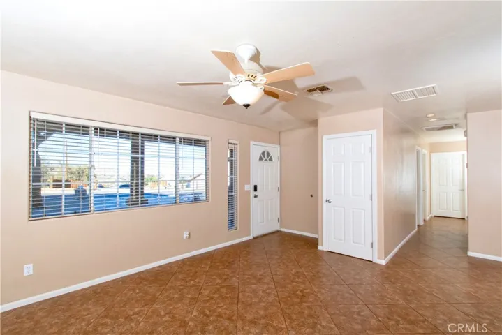 Living room with coat closet at entry