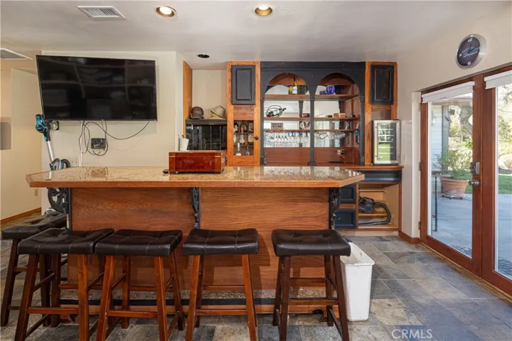 Built in bar and moveable bar in garage with french doors to backyard. .