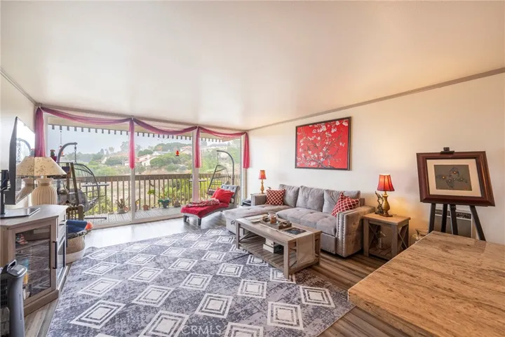 Your view from the kitchen and breakfast bar through the living room to the balcony