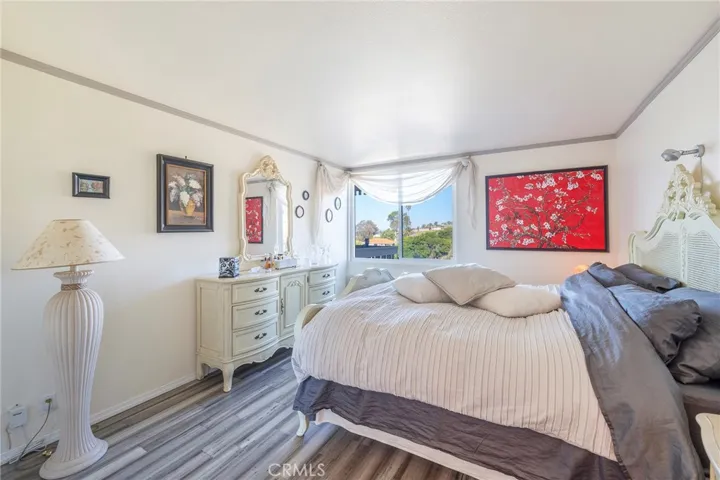Tastefully furnished bedroom with views of the hills.