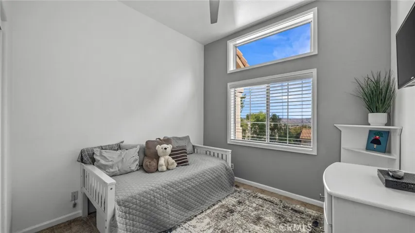 2nd bedroom with vaulted ceilings, ceiling fan, and views galore!