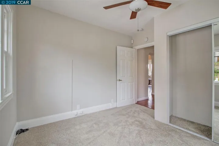 Mirrored closet doors in second bedroom