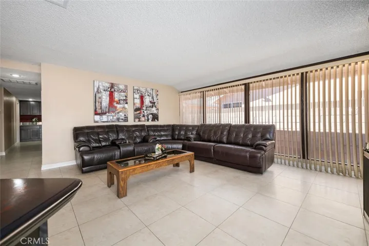 Neutral tile provides endless style and durability. Couch/recliner included.