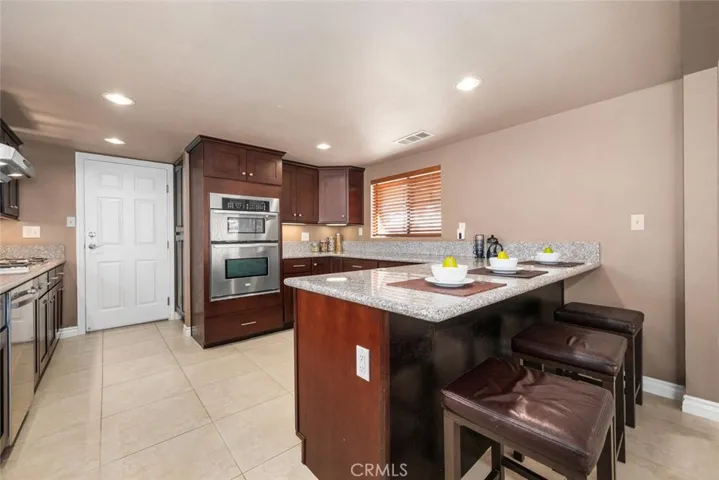 Stainless-steel appliances include stovetop, dishwasher, microwave, oven, garbage disposal.