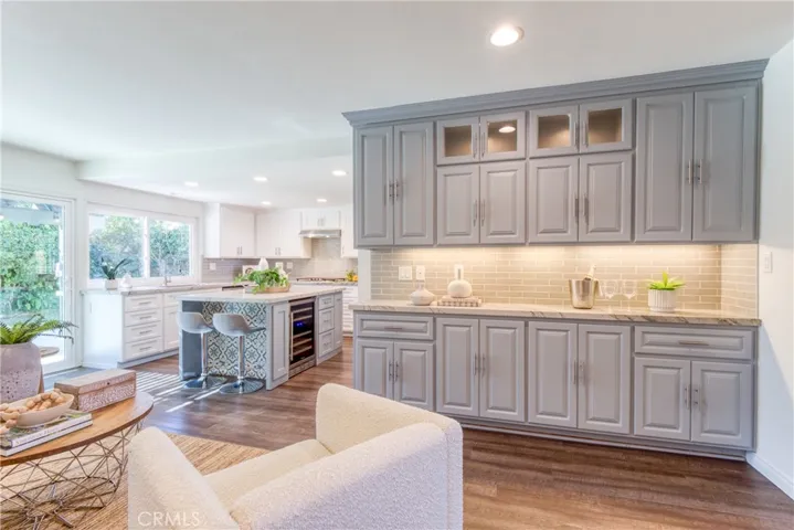 Great room featuring custom built-in cabinetry with a quartz countertop and tile backsplash.  So convenient for daily living as well as entertaining family & guests~