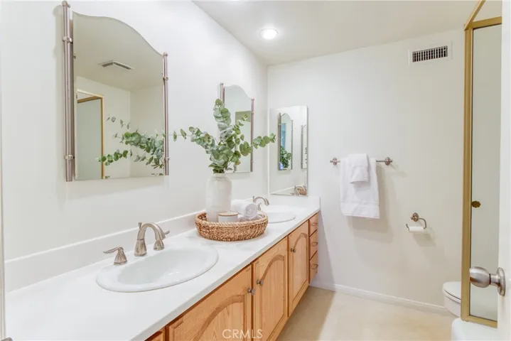 Hall bath with two sinks and tub w/shower overhead!