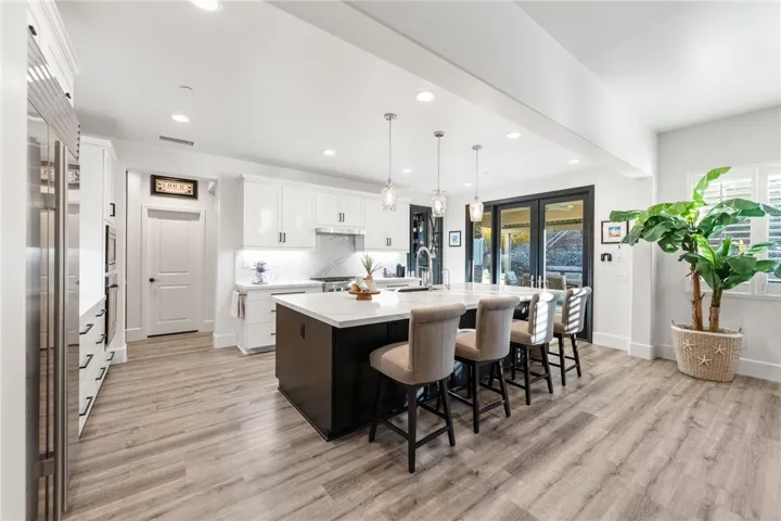 Upgraded kitchen with expansive and newly redone island with extra storage under the seating area