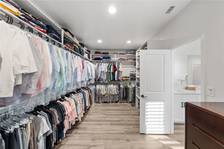 Primary walk-in closet - recently redone to add extra shelving