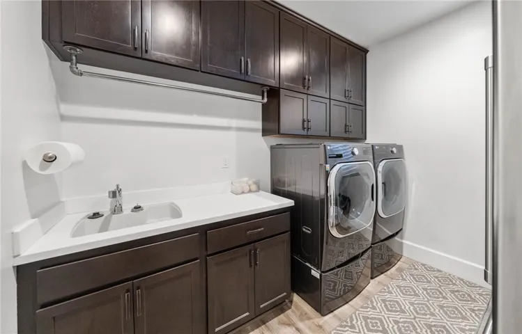 Laundry room with sink and lots of storage + outlet and space for indoor fridge