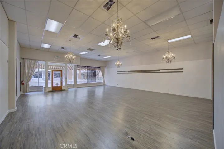Interior of lease space with art hanging rails and stunning chandeliers