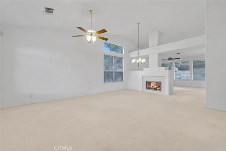 Living room with formal dining area near fireplace