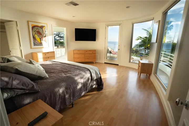 Primary ensuite bedroom (2nd Level) with deck and panoramic ocean views.