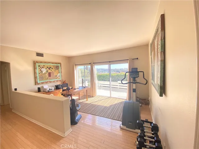 Full office space with exercise equipment, complete with ocean and mountain views.